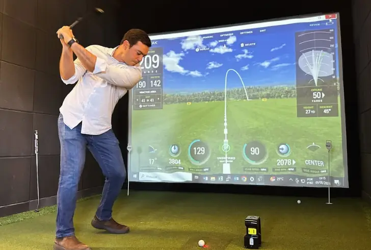 Golfer using fast indoor simulator