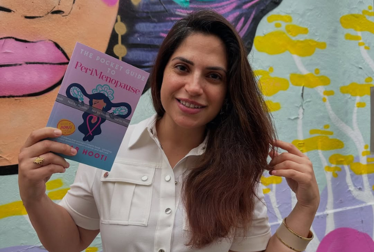 Sahar Hooti is holding her book